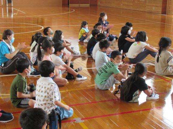 リベリア講座にて、床に座って話を聞く児童たちを横から撮影した写真